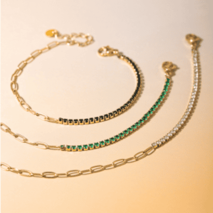 Elegant custom jewelry featuring layered gold chains and sparkling gemstones, perfect for personalized accessory styling.