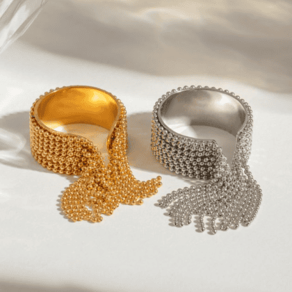 Gold and silver statement rings with beaded and bow accents, perfect for custom jewelry collections. Handcrafted jewelry pieces with intricate detailing from Nayram - Custom Jewelry.