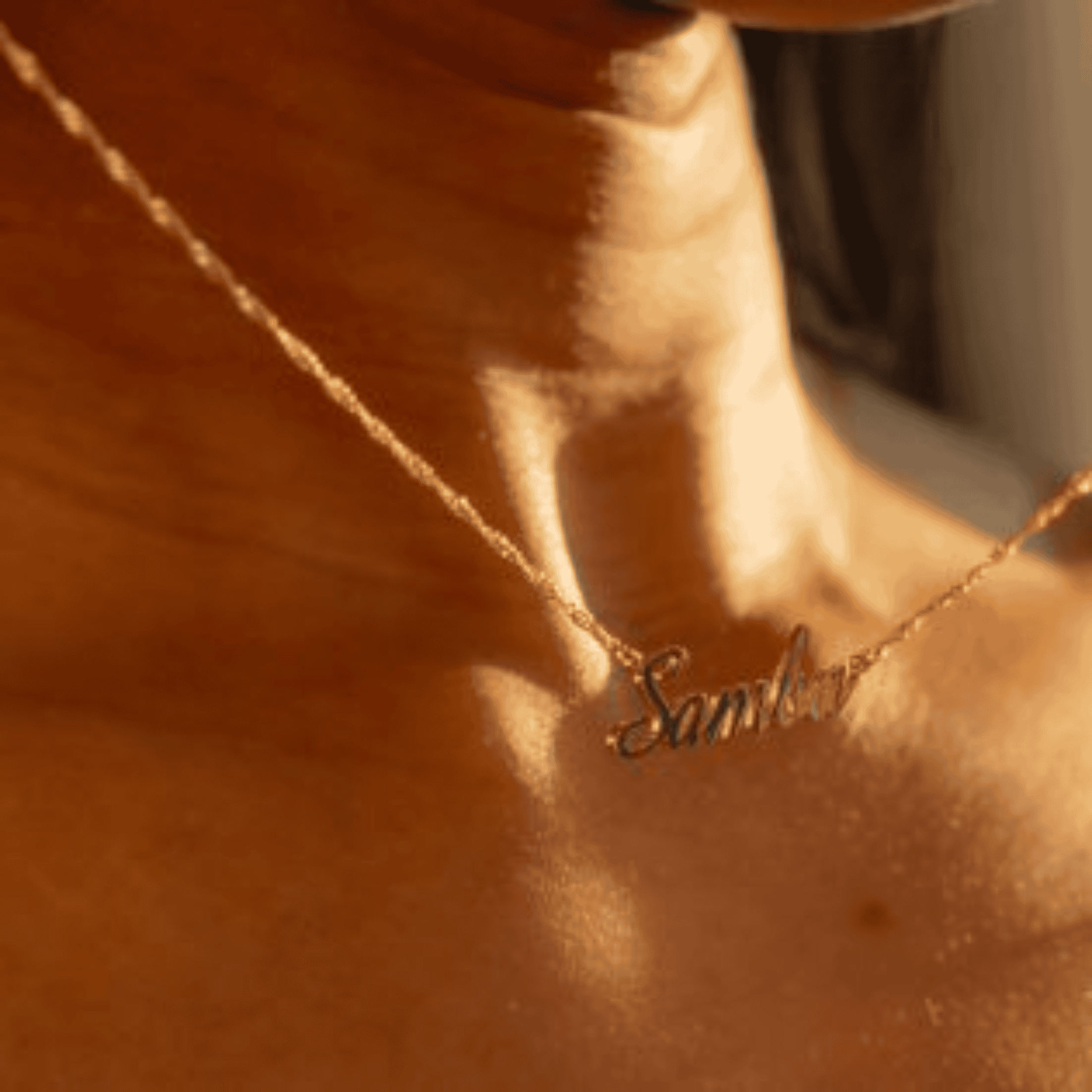 Elegant personalized gold name necklace on a woman's collarbone showcasing custom jewelry design. Perfect for unique, meaningful jewelry gifts and everyday luxury.