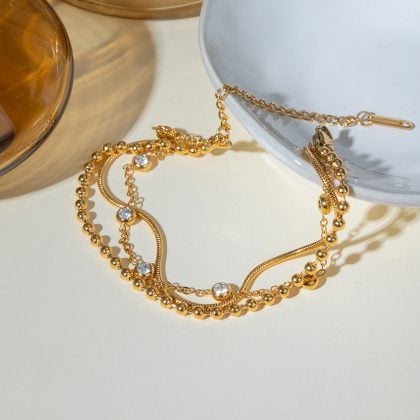 Gold jewelry necklace with sparkling stones, layered and stylish, perfect for custom jewelry designs. Available at Nayram, specializing in unique and personalized jewelry pieces.