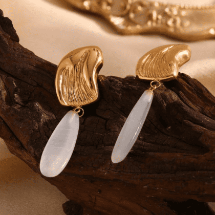 Elegant gold and white statement earrings with unique abstract design and elongated pearl pendant, perfect for customized jewelry and luxury accessories.