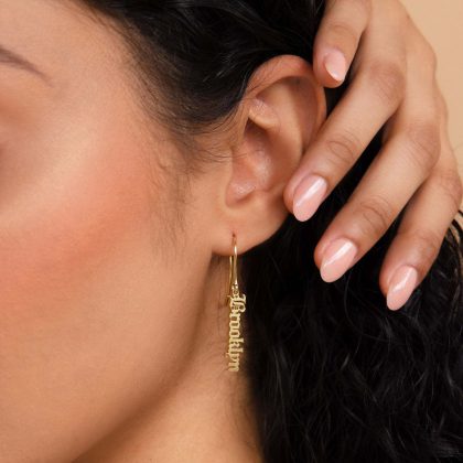 Personalized gold "Breathe" earring in close-up, showcasing custom jewelry design for women, perfect for gift-giving and stylish accessorizing.
