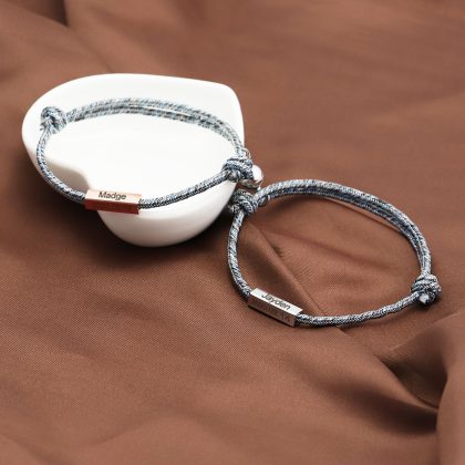 Personalized engraved jewelry bracelets with custom names and dates on sleek metal tags, ideal for special occasions and meaningful gift-giving. Perfect for custom jewelry enthusiasts.