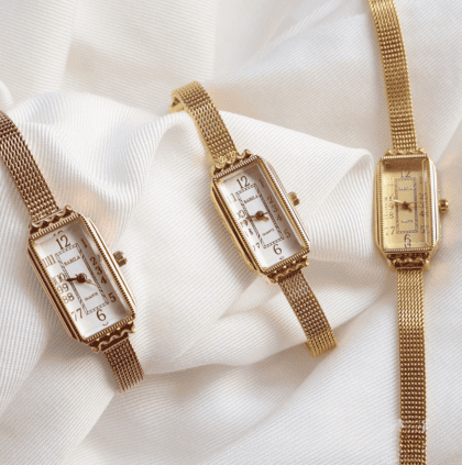 Elegant gold wristwatches with rectangular faces and mesh bands, showcasing custom jewelry craftsmanship. Perfect for stylish accessories or gift ideas.