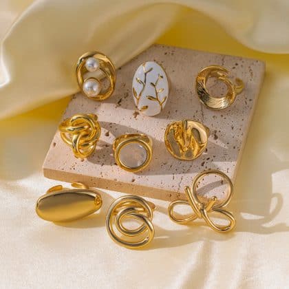 Elegant gold and pearl statement rings featuring modern designs, botanical motifs, and abstract art-inspired styles, perfect for custom jewelry collection.